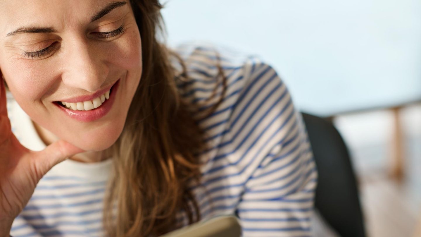 Close-up of a woman's eyes as she looks at a digital screen.