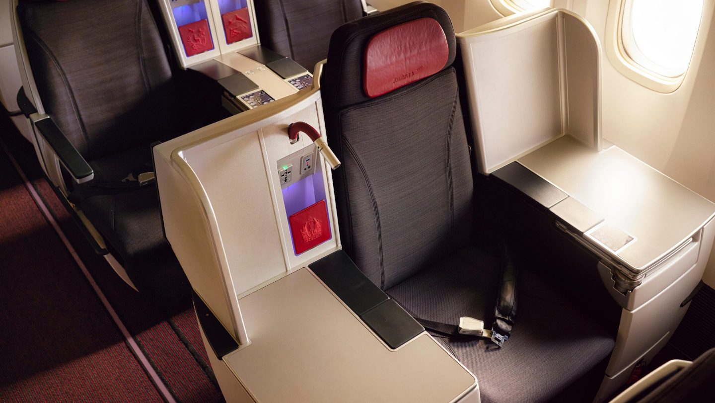Aerial view of airplane seating, displaying multiple rows of seats in the passenger cabin.