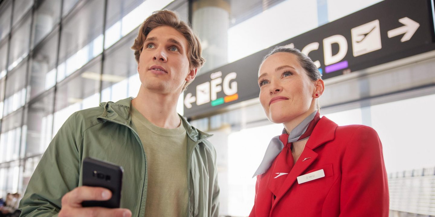 Austrian employee and a man at an airport.