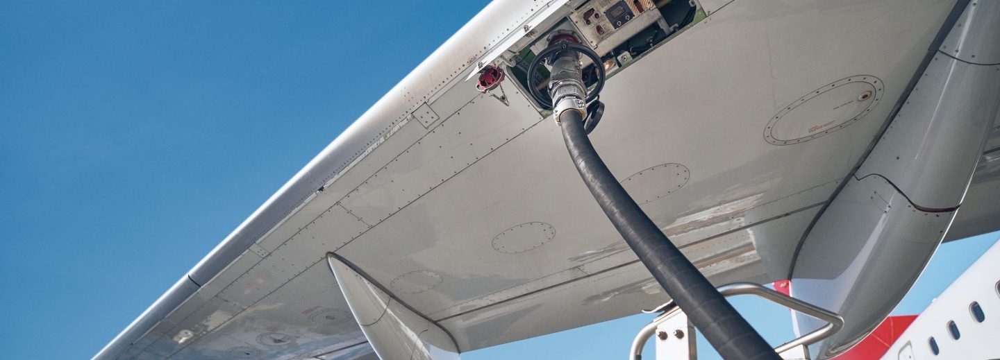 Airplane fueling up on the tarmac.