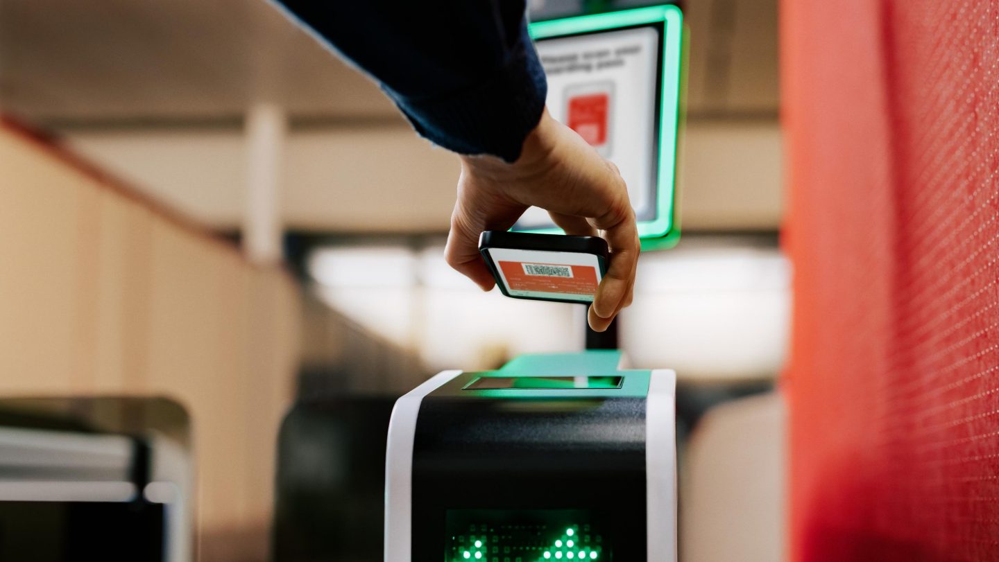 Scanning a digital boarding pass at an electronic gate.