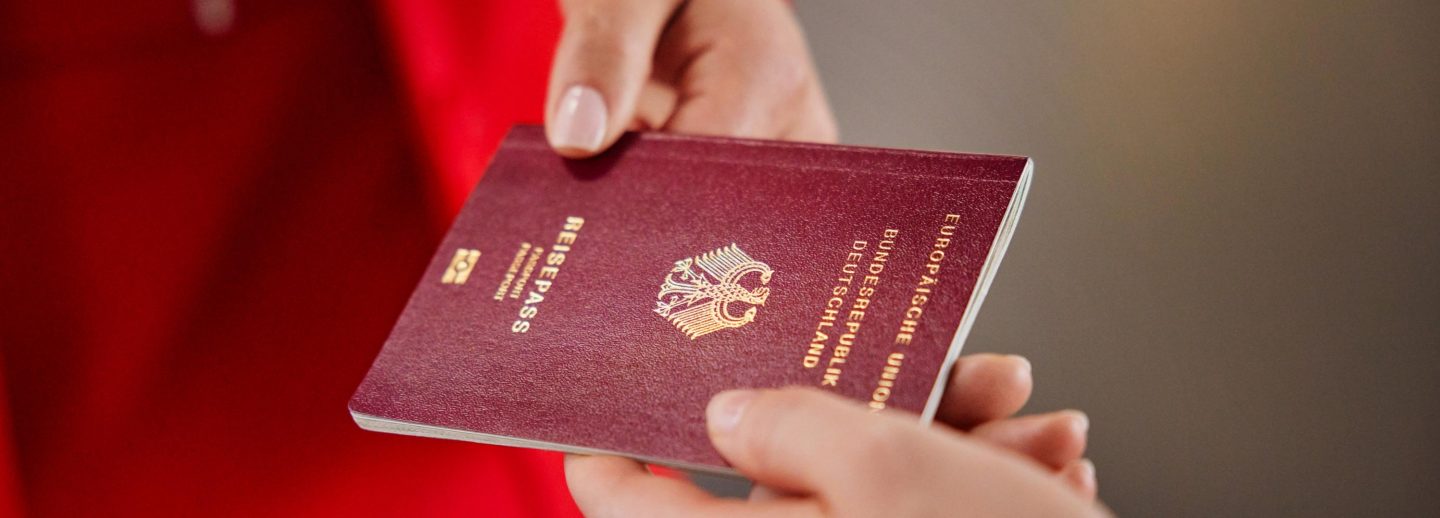 A person holding a passport, symbolizing travel and entry regulations.