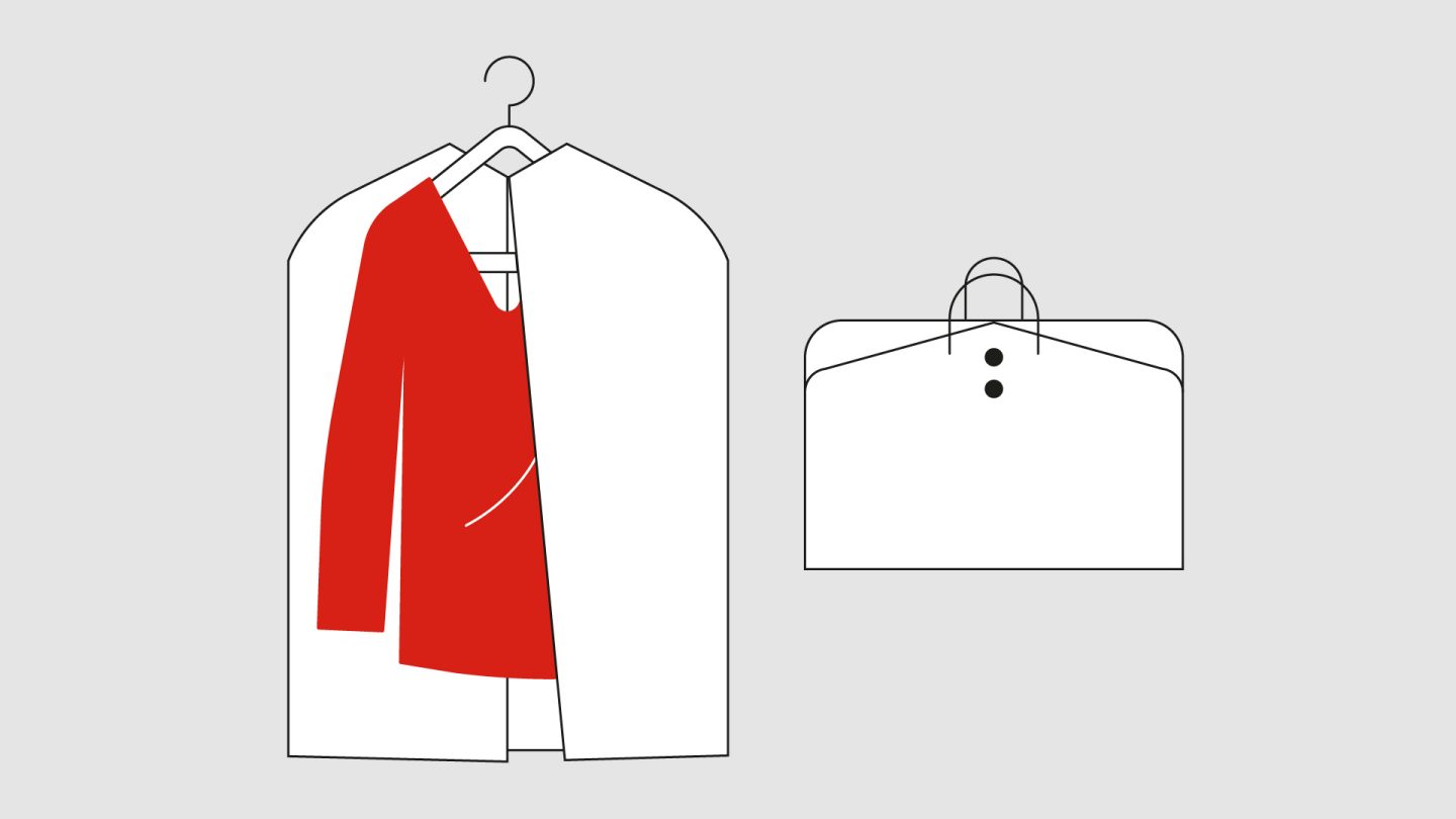 Red garment on a hanger with a white cover, next to a white bag.