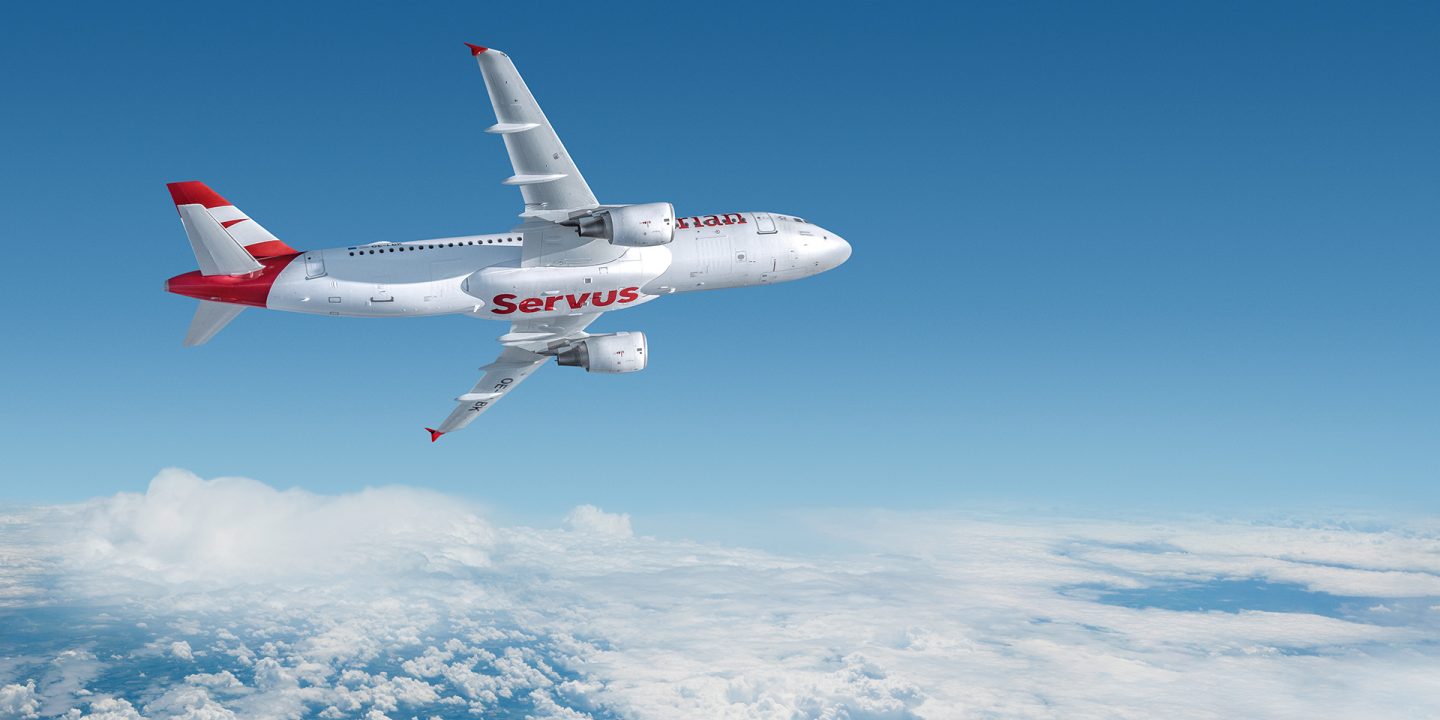 An airplane with Austrian painting in the clouds