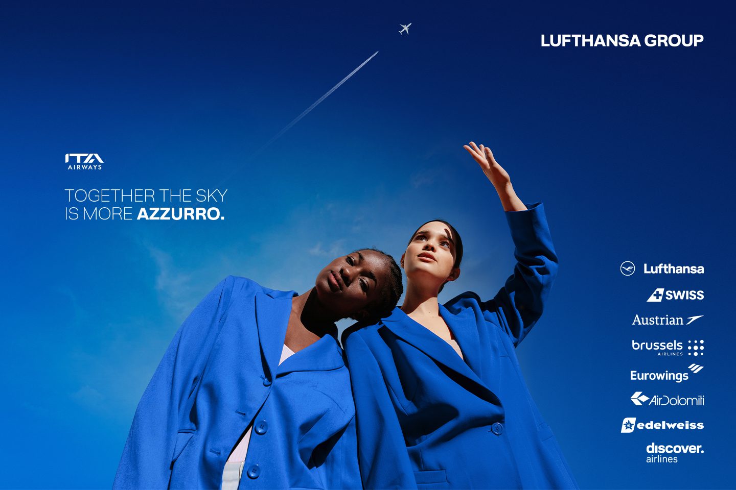 A couple relaxing on an airplane with blue lighting.